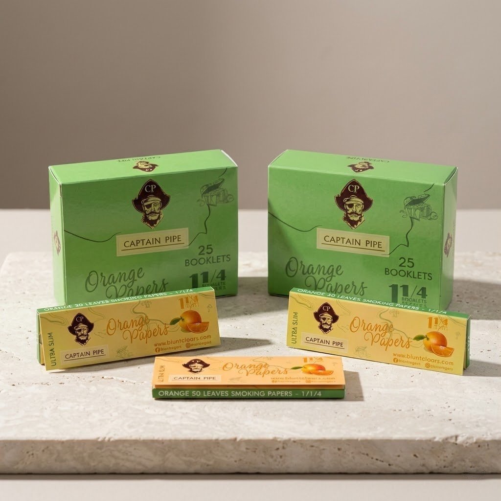 Cueros Papeles Captain Pipe Orange #9: librillos y dos cajas sobre piedra clara